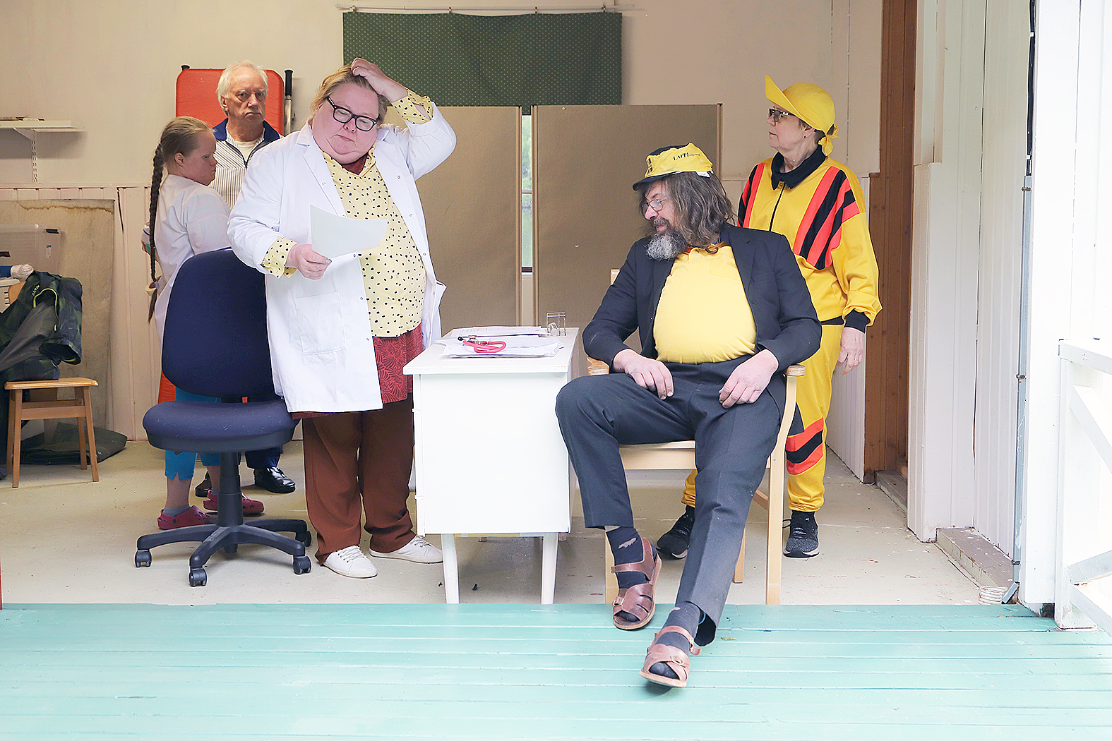 Vuokonjärven Muistilääke. Saara-lääkäri (Ritva Väyrynen) saa raapia moneen kertaan päätään, mitä Paavon (Jukka Nykänen) kanssa pitäisi tehdä. Vaimona Irma Ahonen (oik.) ja hoitajina Selma Heikkinen ja Teuvo Puhakka.