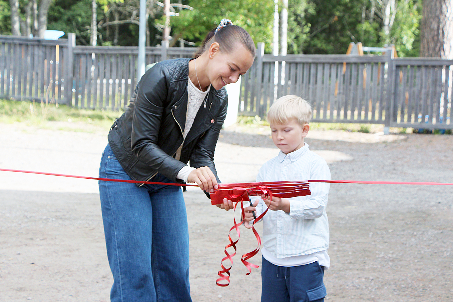 Kolin koulun uusi piha otettiin juhlallisesti käyttöön. Nauhan leikkasi Mauri Puumalainen Noora Palovuoren avustamana.
