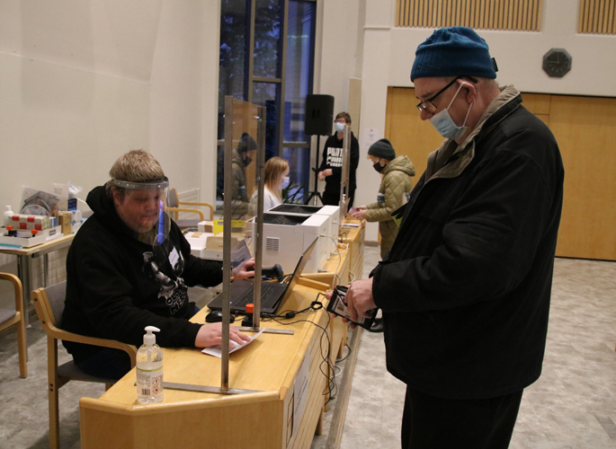 Urpo Lehikoisella on ollut tapana äänestää vaaleissa ennakkoon, useimmiten jo ensimmäisenä ennakkoäänestyspäivänä, kuten nyt aluevaaleissa. Vaalitoimitsijoista palvelemassa Heikki Vanninen. Kuva Juha-Matti Junkkari