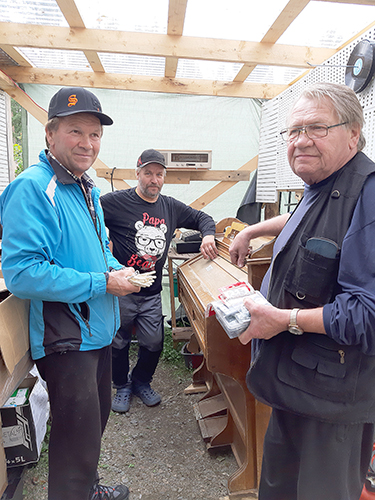 Aamun ensimmäiset asiakkaat Seppo (vas.) ja Hanski Hyttinen (oik.) eivät lähteneet Reiskan Rompetorilta tyhjin käsin. Yrittäjä Reino Eronen myhäilee taustalla tyytyväisenä.